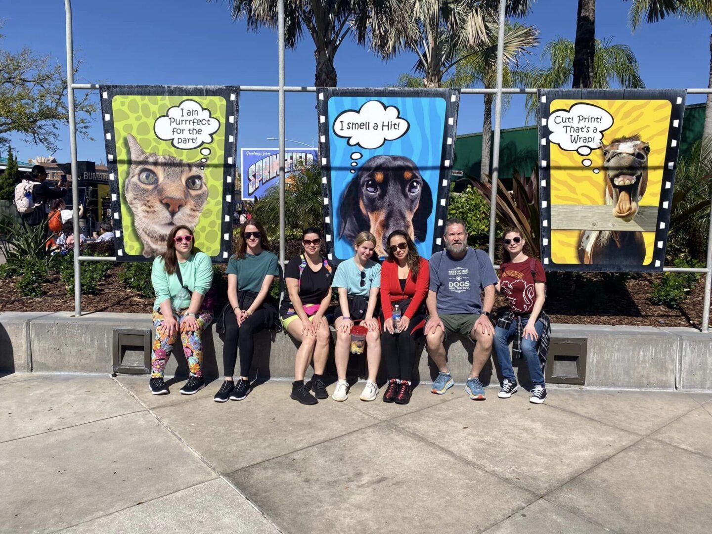 A group of people sitting on top of a bench.